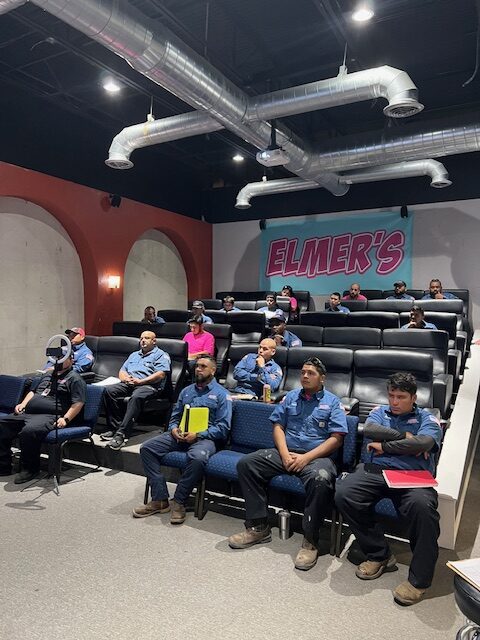 A group of people sitting in the middle of an auditorium.