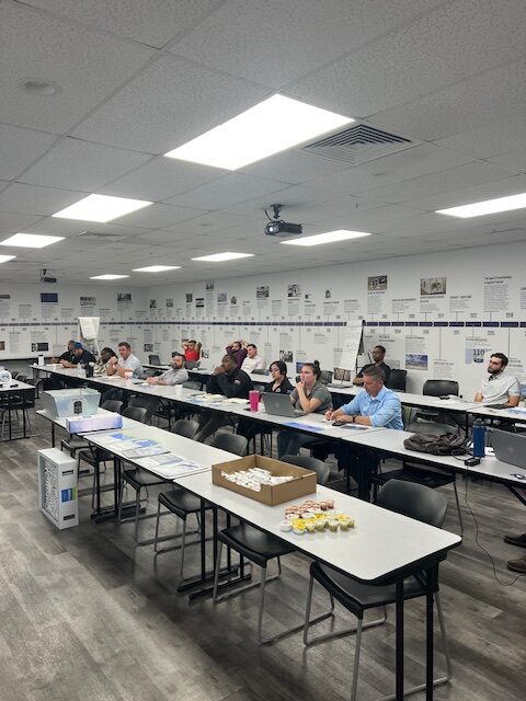 A group of people sitting at tables in a room.